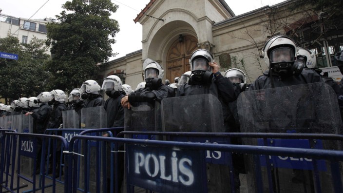Turkish riot police stand guard outside of the French Consulate during a protest against the killing of three Kurdish activists, in central Istanbul