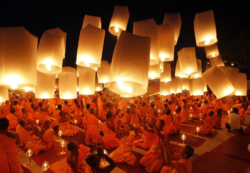 Buddhist monks launch paper lanterns into the sky in Suphan Buri province