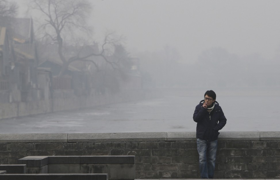 A man smokes near the Forbidden City in central Beijing