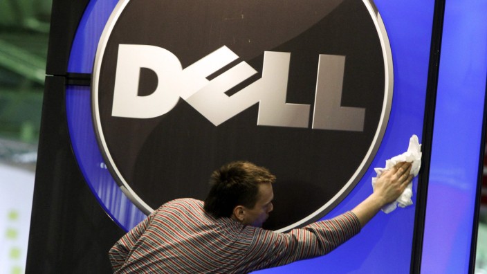 File of a man wiping logo of Dell IT firm at CeBIT exhibition centre in Hannover