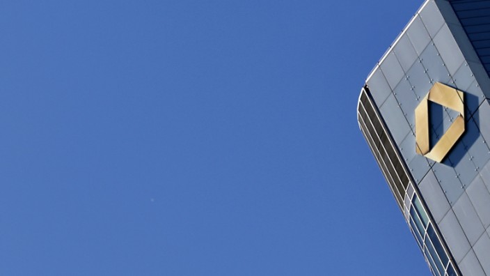 An airplane leaves his vapour streams as it flies over the head quarter of Germany's Commerzbank in Frankfurt