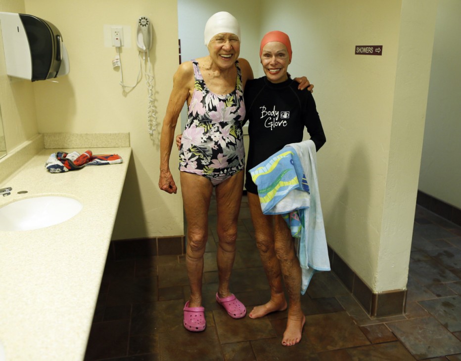 Teodora Spanjers poses with Ginny Bravos in a swimming pool locker room in Sun City