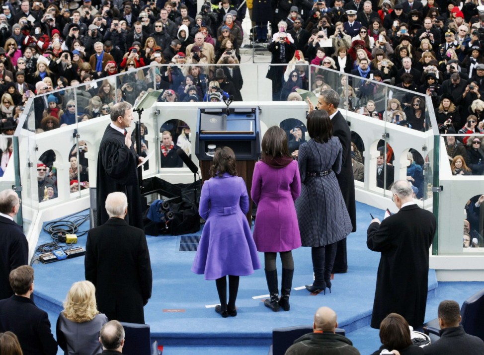 U.S. President Barack Obama takes the oath from U.S. Supreme Court Justice John Roberts as his family looks on during swearing-in ceremonies on the West front of the U.S Capitol in Washington