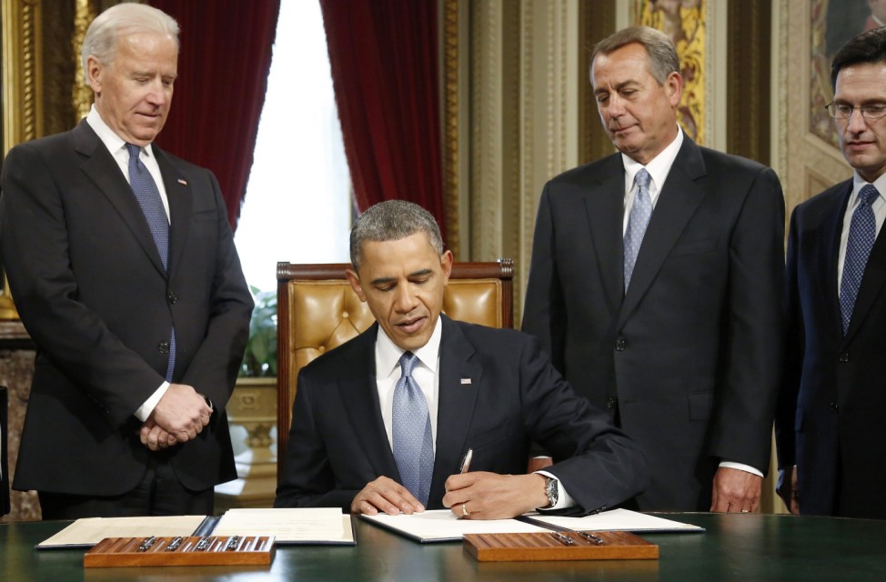 Obama signs a proclamation directly after swearing-in ceremonies in the U.S Capitol in Washington