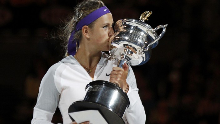 Victoria Azarenka of Belarus poses with The Daphne Akhurst Memorial Cup after defeating Li Na of China in their women's singles final match at the Australian Open tennis tournament in Melbourne