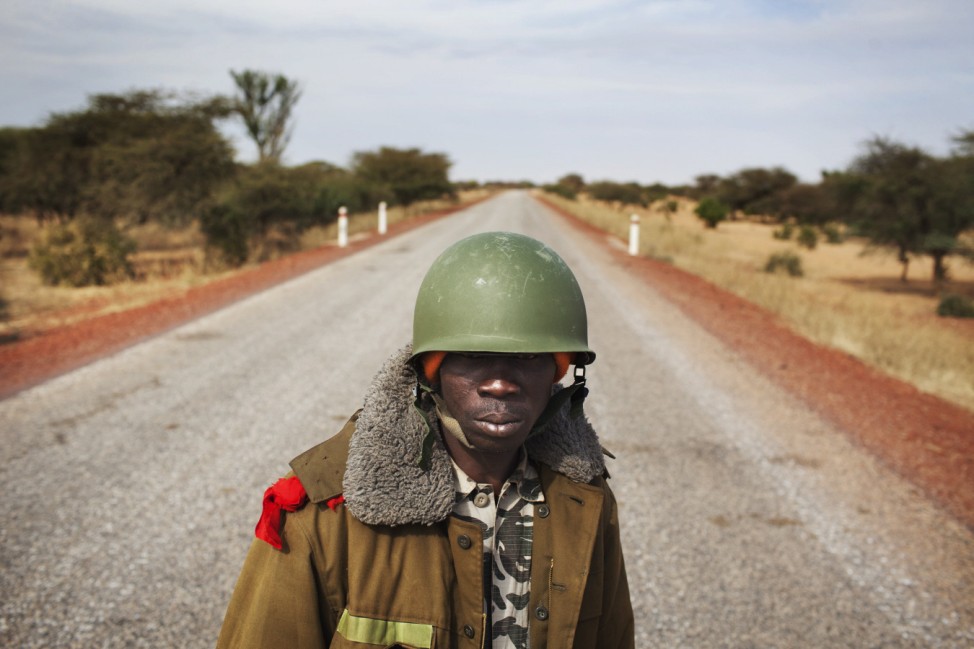 Malian soldier Ousmane Cisse stands guard on an open road outside Sevare, Mali