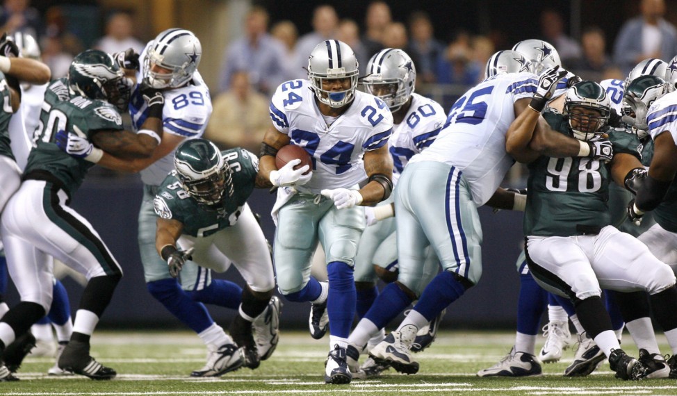 Cowboys running back Barber breaks through the line against the Eagles NFL football game in Arlington