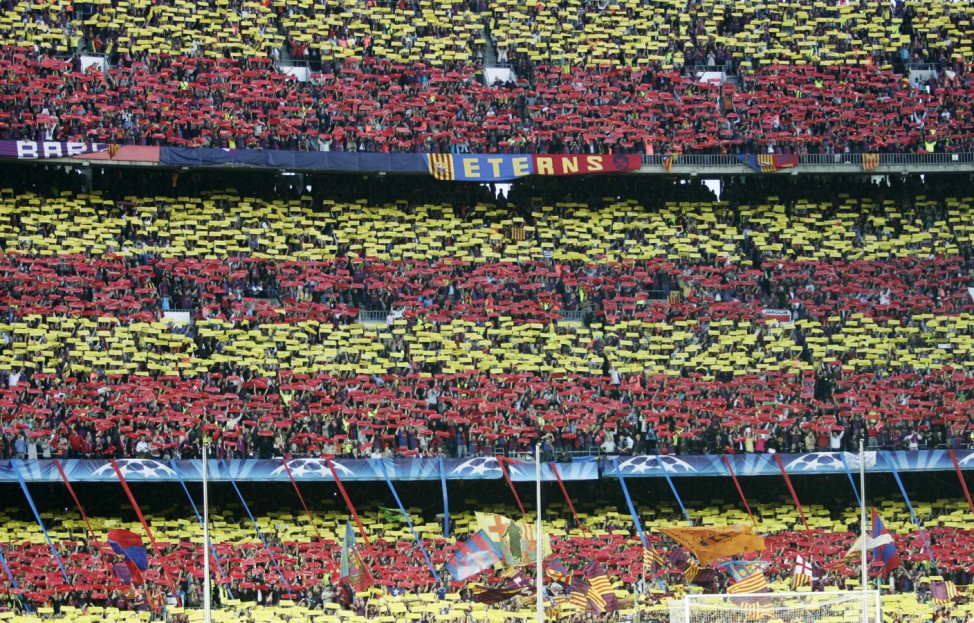 Barcelona supporters hold up coloured papers before the start of their Champions League semi-final second leg soccer match against Inter Milan at the Nou Camp stadium in Barcelona