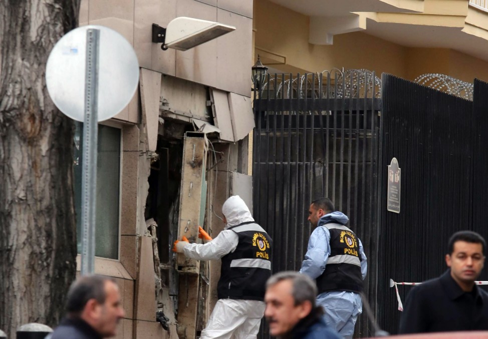 Turkish police bomb experts inspect the site after an explosion at the entrance of the U.S. embassy in Ankara