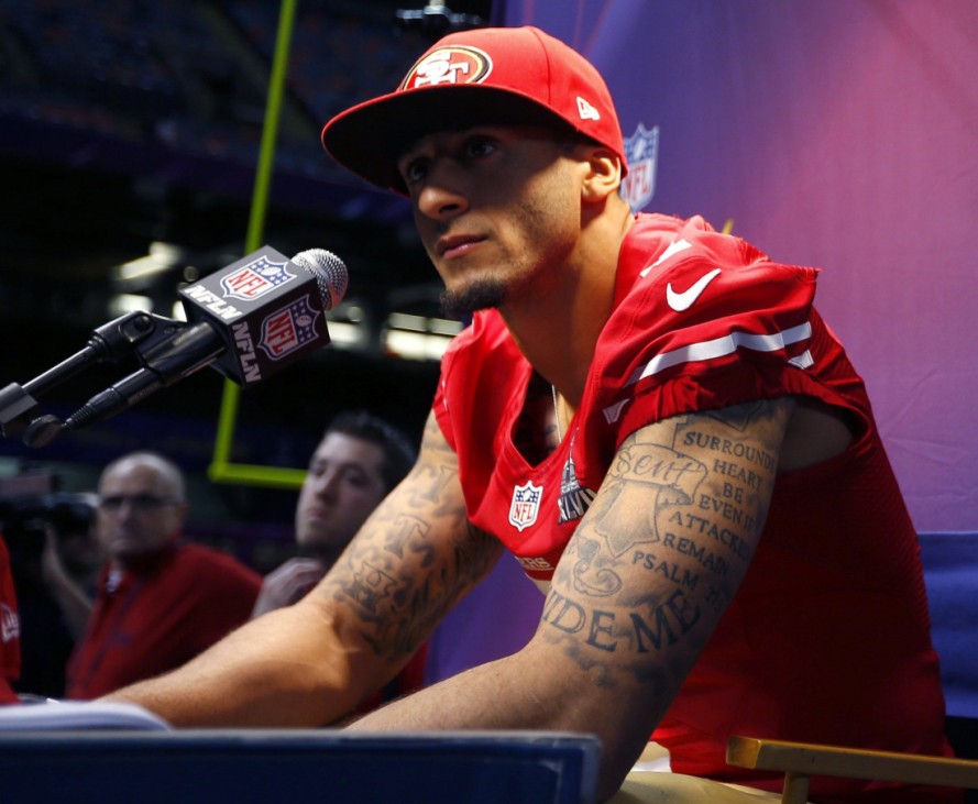 San Francisco 49ers quarterback Colin Kaepernick speaks froma  podium during Media Day for the NFL's Super Bowl XLVII in New Orleans