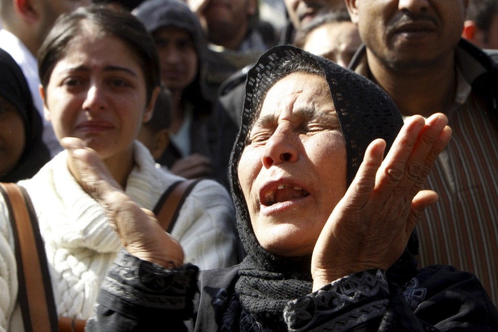 A relative of a man, who died in clashes between police and demonstrators, mourns during his funeral in Cairo