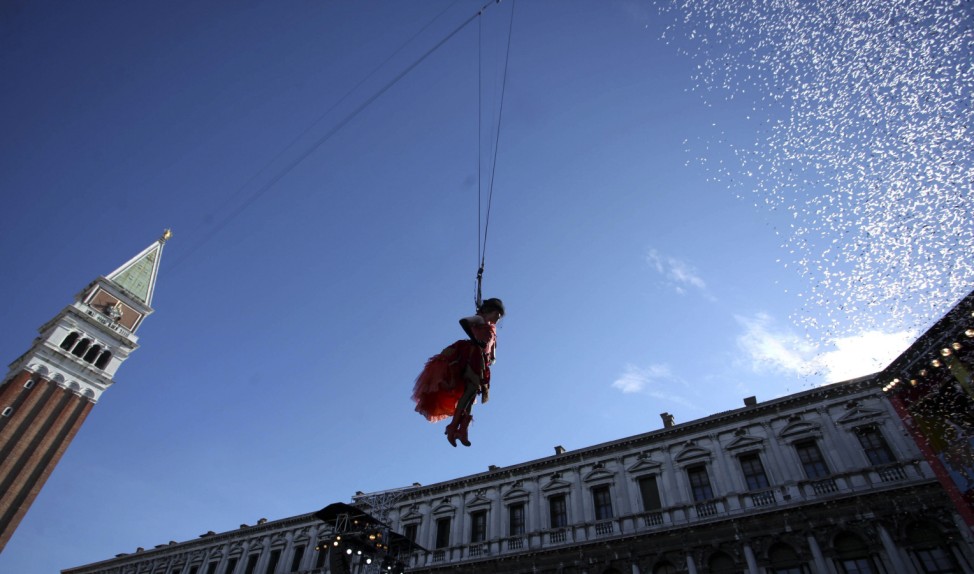 The traditional Columbine descends from Saint Mark's bell tower on an iron cable during the Venetian Carnival in Venice