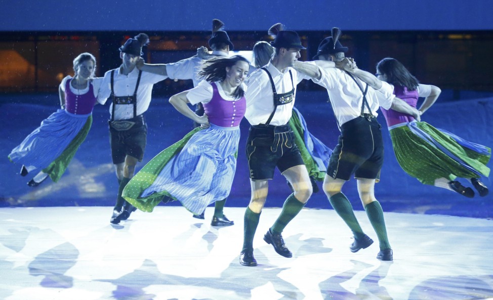 Performers in traditional Alpine costumes dance during the opening ceremony of the World Alpine Skiing Championships in Schladming