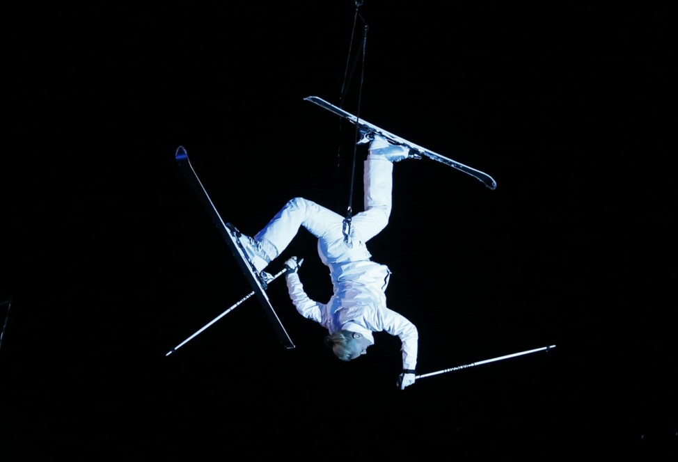 A performer hangs upside down on a cable during the opening ceremony of the World Alpine Skiing Championships in Schladming