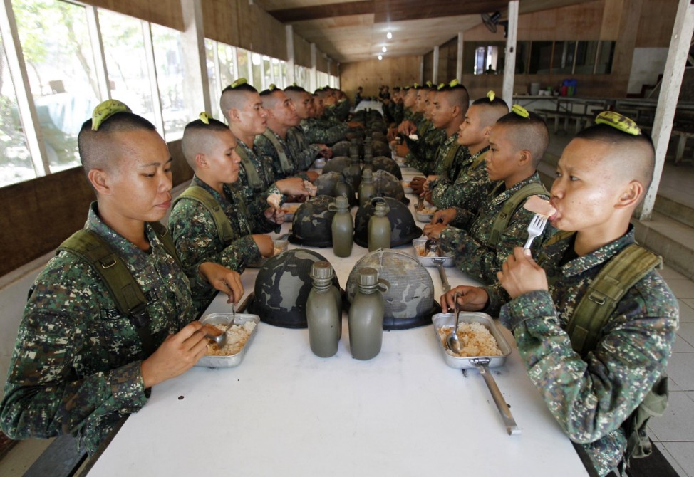 Newly recruited female marines take their lunch with fellow soldiers inside the marine headquarters Ternate