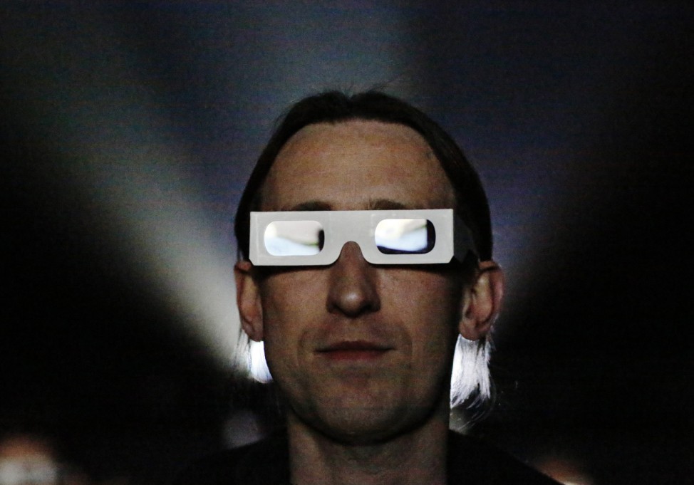 A member of the audience wears a pair of 3d glasses while watching German electronic band Kraftwerk perform with a 3d stage set at the Tate Modern in London