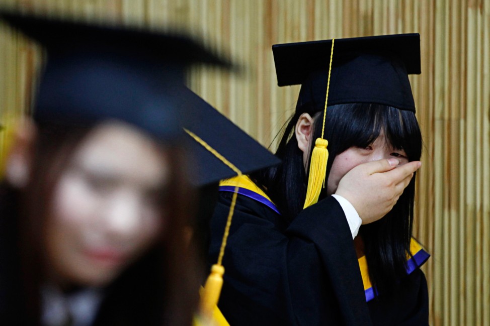 A high school graduate who escaped from North Korea weeps during a graduation ceremony at Hangyeore High School in Anseong