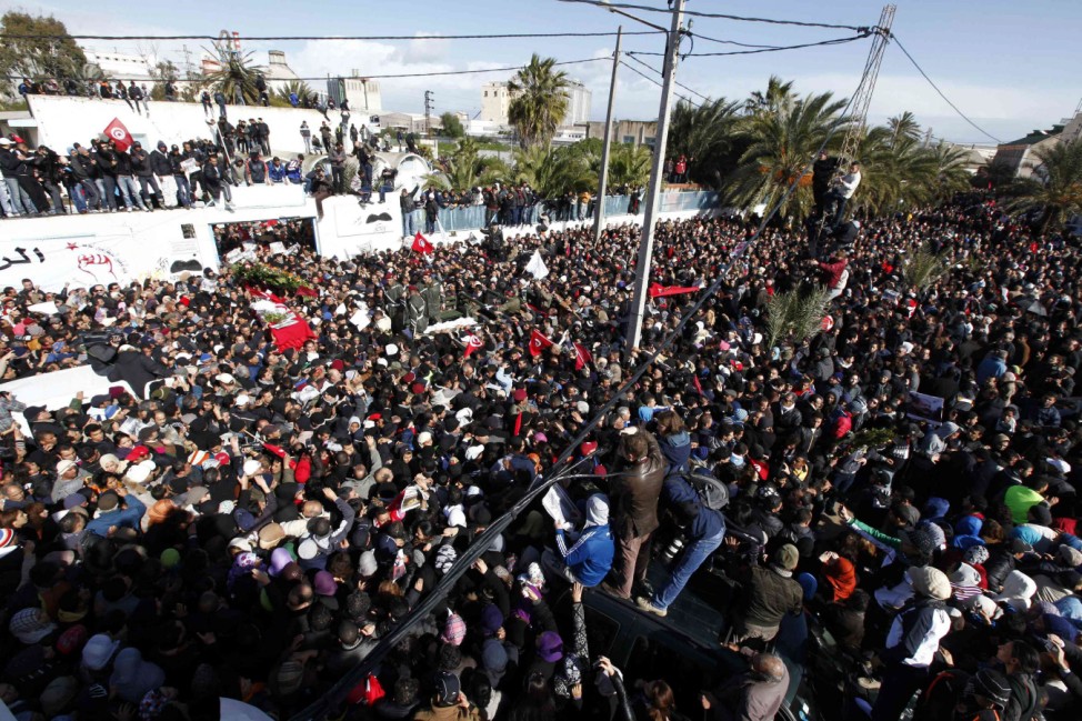 Mourners carry the coffin of slain opposition leader Chokri Belaid during his funeral procession towards the nearby cemetery of El-Jellaz, where he is to be buried, in the Jebel Jelloud district of Tunis