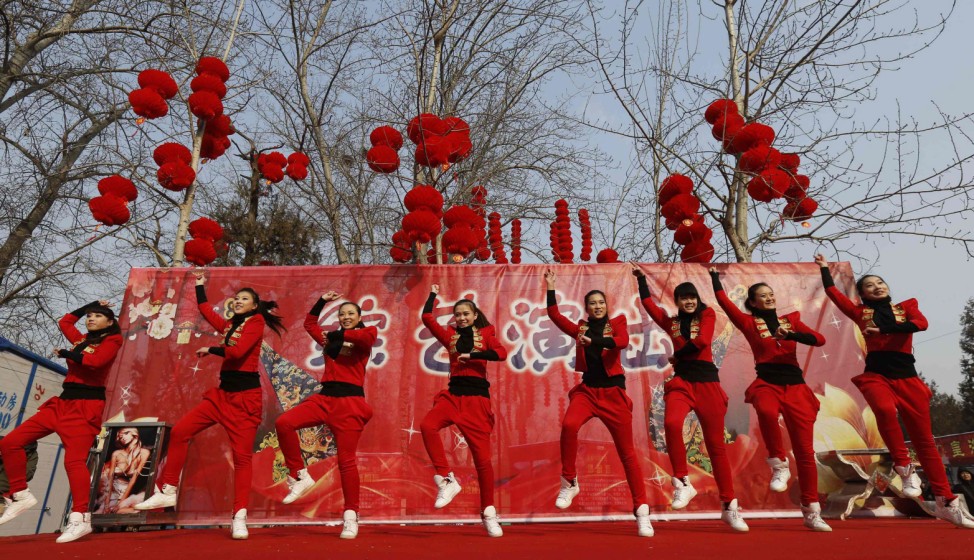 Dancers perform to 'Gangnam Style' during the temple fair in Ditan Park, also known as the Temple of Earth, in Beijing