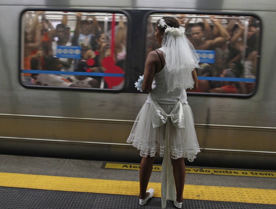 Reveller waits for a subway train to the Sambadrome for the first night of the annual Carnival parade in Rio de Janeiro