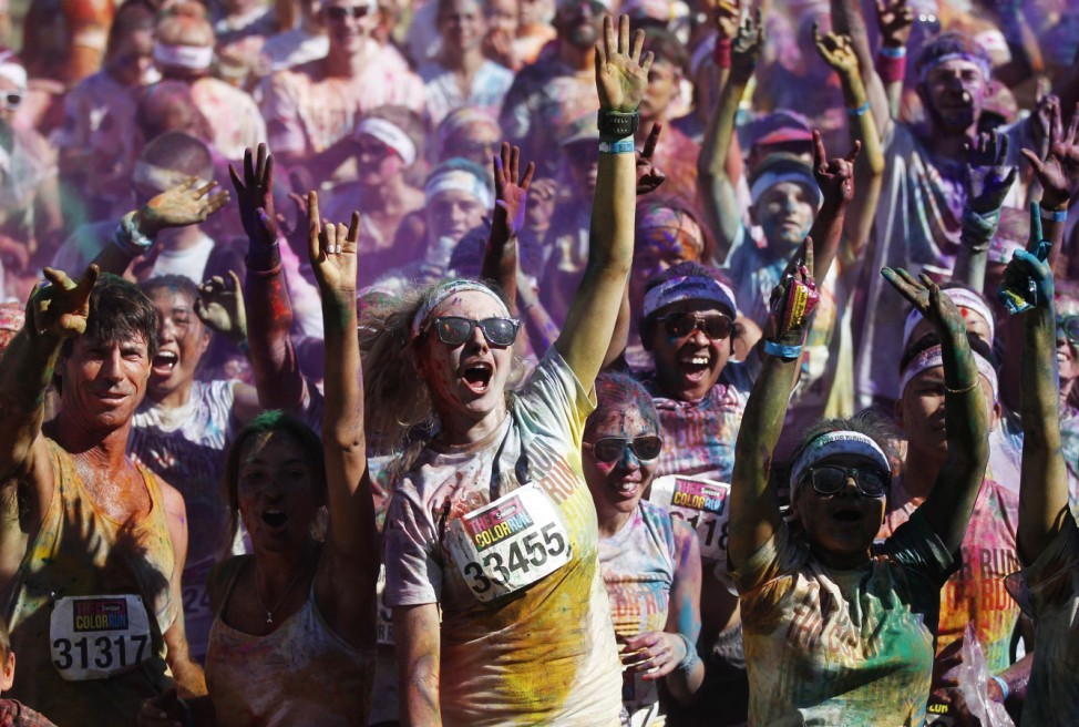 Runners cheer after they finish the Color Run at Sydney Olympic Park