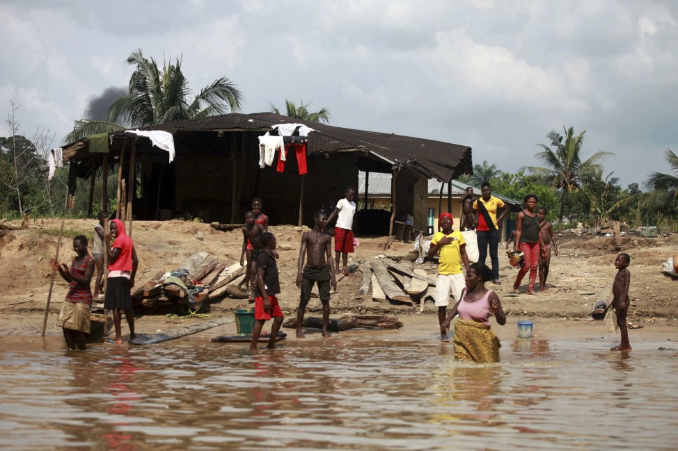 People wash and bathe in a village on the banks of the river Nun in Nigeria's oil state of Bayelsa