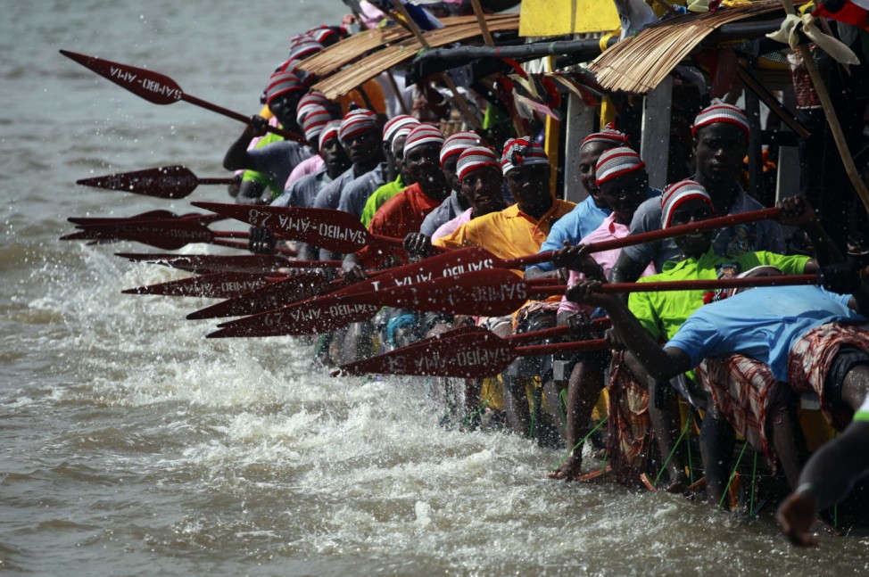 Youths take part in a traditional boat regatta for the burial ceremony of a local chief in the coastal town of Twon Bass in Nigeria's oil state of Bayelsa in the Delta region