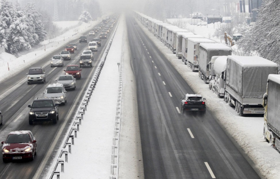 Snow-covered lorries are pictured parked by the side of a highway in Brezovica, near Ljubljana