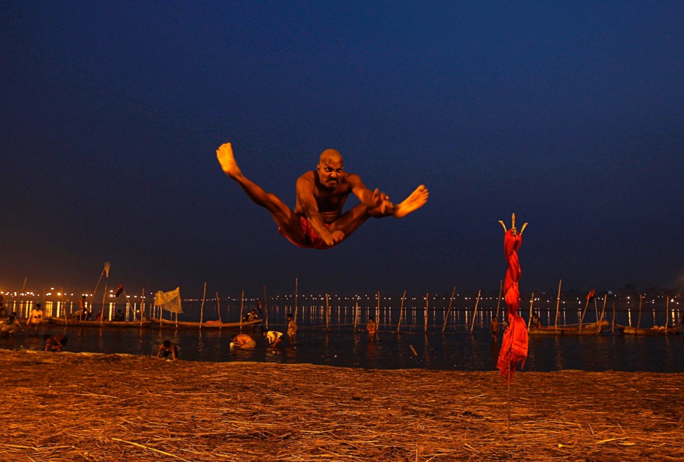 A devotee exercises before taking holy dip on banks of Ganges during ongoing 'Kumbh Mela', or Pitcher Festival, in Allahabad