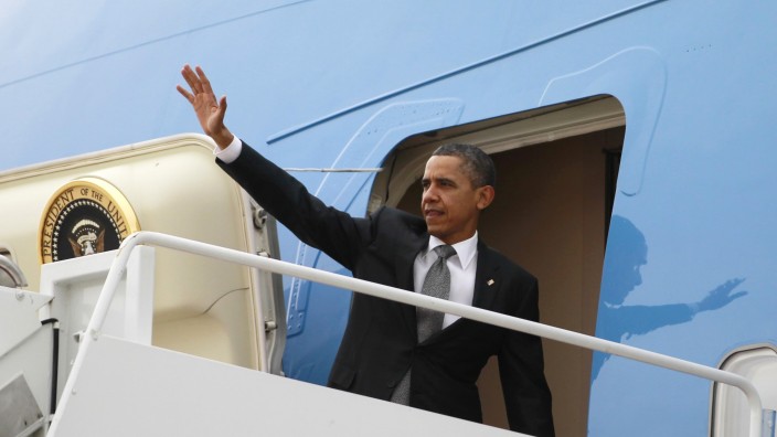 U.S. President Barack Obama waves from Air Force One at Andrews Air Force base near Washington