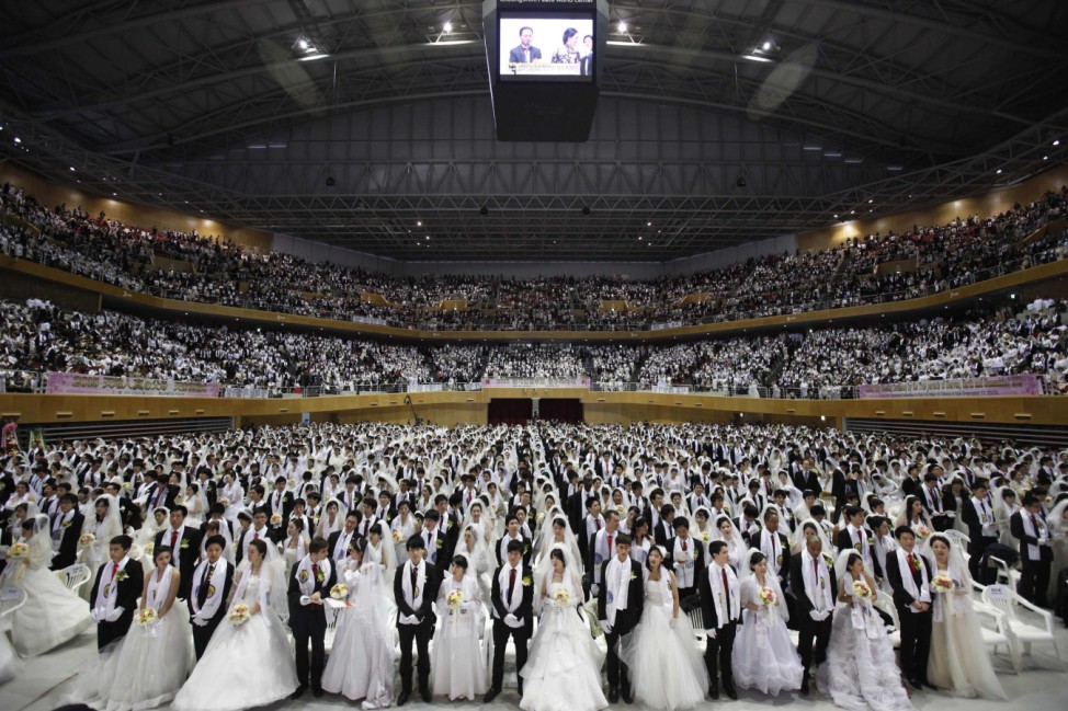 Thousands of newlyweds attend a mass wedding ceremony of the Unification Church at Cheongshim Peace World Centre in Gapyeong