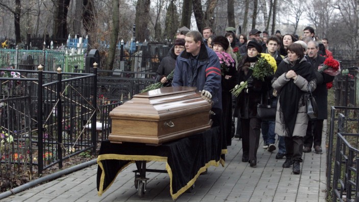 Friends and relatives follow the coffin of Magnitsky during his funeral at a cemetery in Moscow