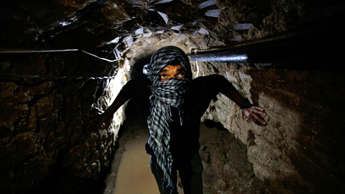 Palestinian works inside a smuggling tunnel flooded by Egyptian forces beneath the Egyptian-Gaza border in Rafah