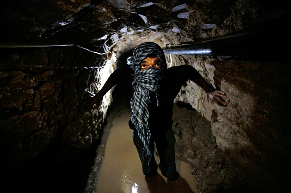 Palestinian works inside a smuggling tunnel flooded by Egyptian forces beneath the Egyptian-Gaza border in Rafah