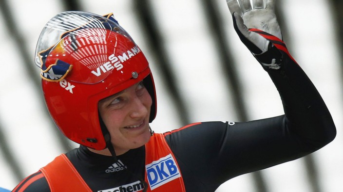 Germany's Huefner reacts after winning the women's luge World Cup test event at the 'Sanki' sliding center in the winter sport resort of Rosa Khutor