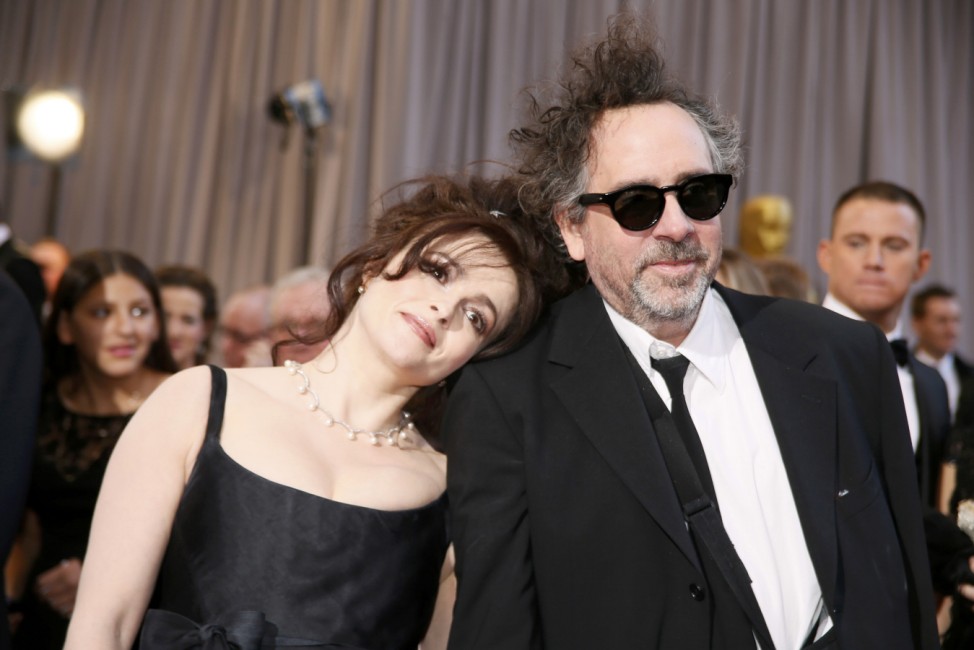 British actress Helena Bonham Carter rests her head on the shoulder of her partner director Tim Burton at the 85th Academy Awards in Hollywood, California