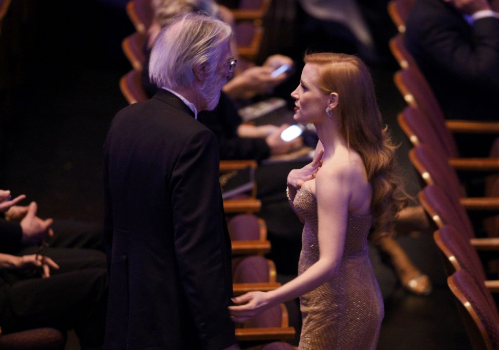 Actress Jessica Chastain speaks with Austrian director Michael Haneke before the start of the 85th Academy Awards in Hollywood