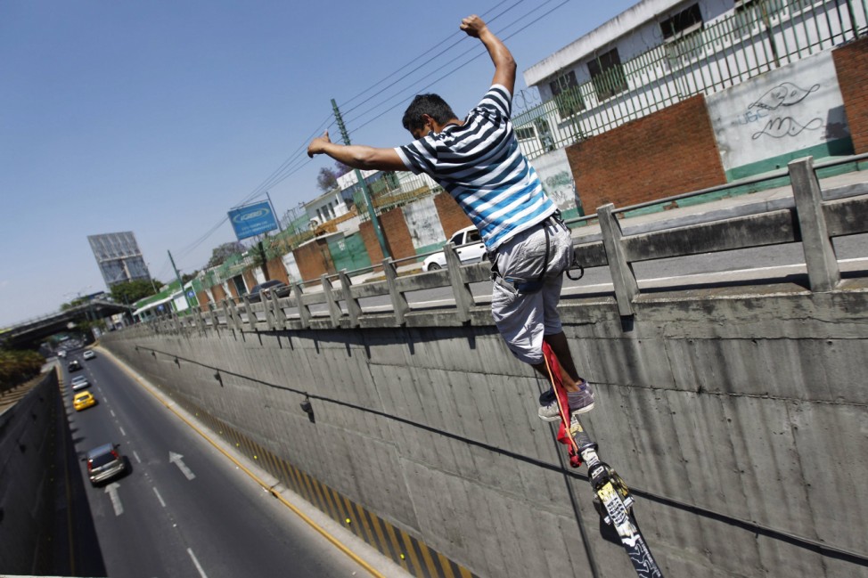 Luis Amezquita practices slacklining over the Periferico avenue in Guatemala City