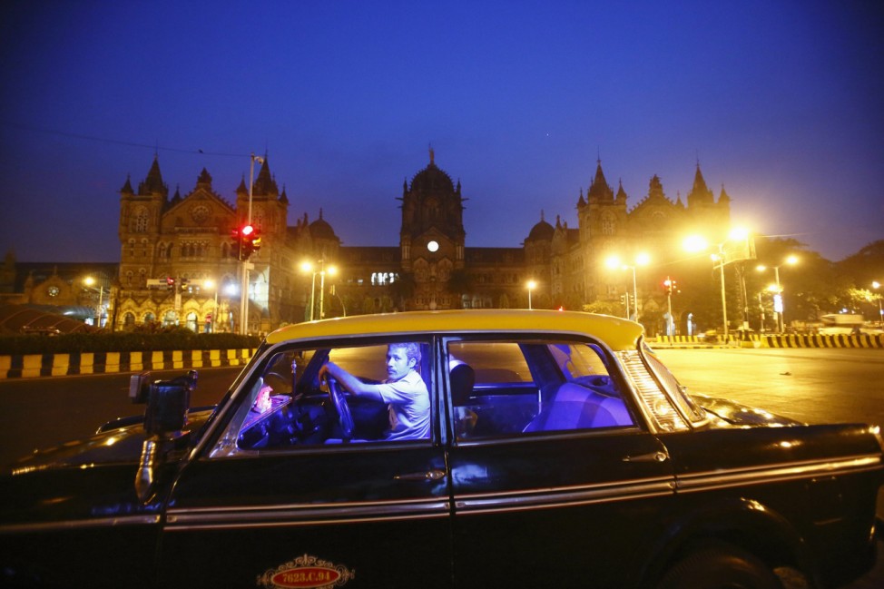 A cab driver waits for commuters outside the Chhatrapati Shivaji Terminus Railway Station