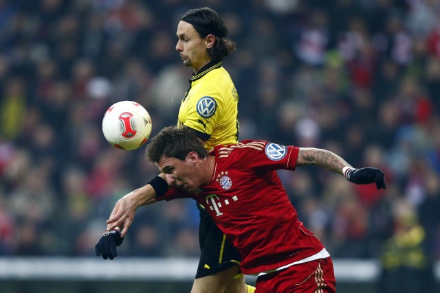 Mario Mandzukic of Bayern Munich challenges Neven Subotic of Borussia Dortmund during their German soccer cup, DFB Pokal, quarter-final soccer match in Munich