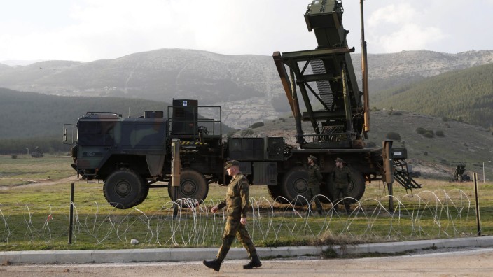 Soldiers of the German armed forces Bundeswehr stand next to the Patriot system before the arrival of Germany's Chancellor Angela Merkel at a Turkish military base in Kahramanmaras