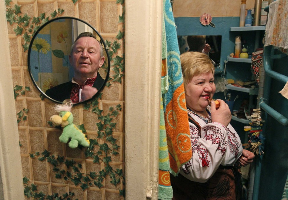 Milevsky and Stolyarenko stand in their apartment as they prepare to attend an amateur dance gathering in Kiev
