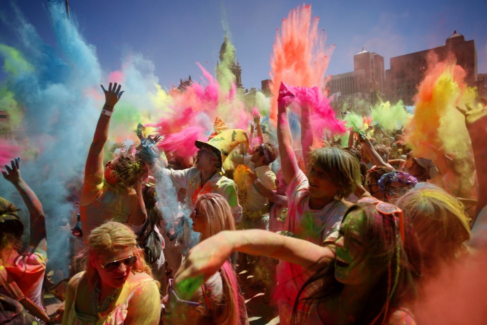 Revellers are covered in coloured cornflour powder as they take part in the Holi One festival in Cape Town