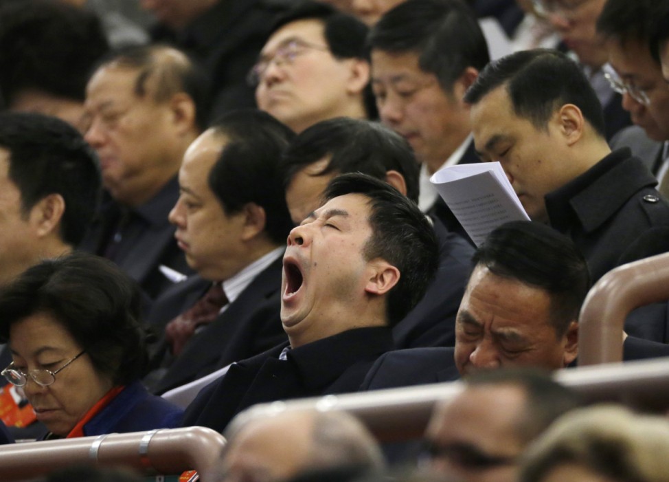 A delegate of the CPPCC yawns during the opening ceremony of NPC  in Beijing