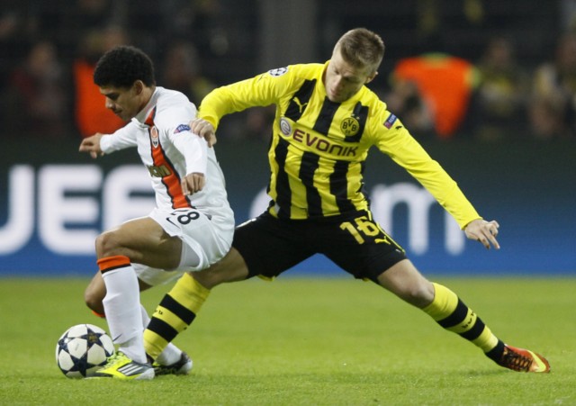 Borussia Dortmund's Blaszczykowski tackles Taison of Shakhtar Donetsk during their Champions League soccer match in Dortmund