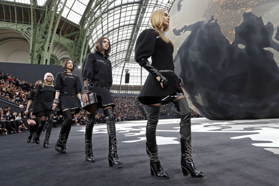 Models present creations by German designer Lagerfeld for French fashion house Chanel as part of his Fall-Winter 2013/2014 women's ready-to-wear fashion show during Paris fashion week