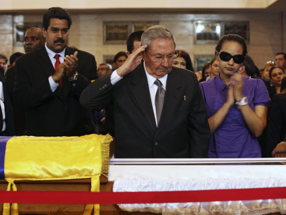 Cuba's President Castro salutes the body of late Venezuelan President Chavez at the military academy in Caracas