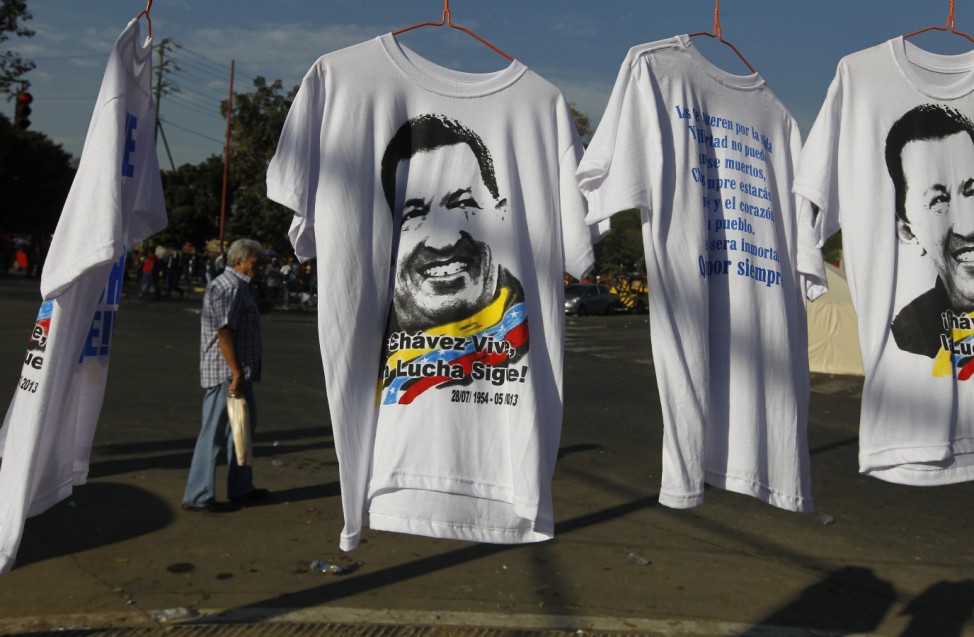 Souvenir T-shirts of Venezuela's late President Hugo Chavez are offered for sale as thousands waited to view his body in state in Caracas