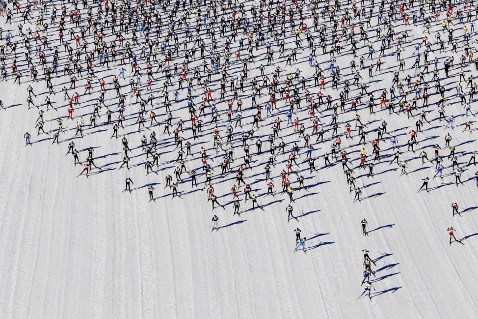 Cross-country skiers start during the Engadin Ski Marathon on the frozen Lake Sils near the village of Maloja