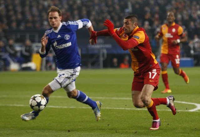 Schalke 04's Hoewedes tackles Yilmaz of Galatasaray during their Champions League soccer match in Gelsenkirchen